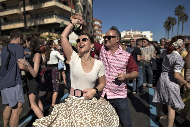 A couple dressed in fifties-style outfits dance during the 29th Rockin' Race Jamboree International Festival in Torremolinos, southern Spain, on February 4, 2023. (Photo by Jorge Guerrero/AFP Photo)