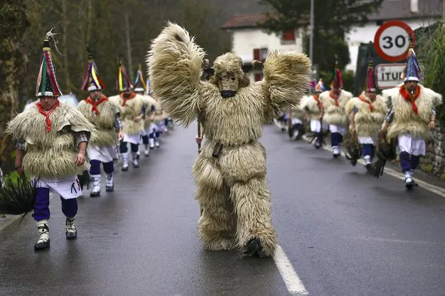 A group of Joaldunaks take part in the Carnival between the Pyrenees villages of Ituren and Zubieta, northern Spain, Monday, January 31, 2022. For two years the carnival has been cancelled due to COVID-19, however this year once again companies of Joaldunak (cowbells) made up of residents of two towns, Ituren and Zubieta, paraded the streets in traditional costumes. (Photo by Alvaro Barrientos/AP Photo)