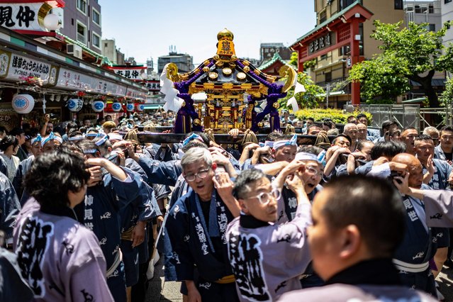 Participants carry a portable shrine “mikoshi” on the second day of the annual Sanja Matsuri festival in the Asakusa district of Tokyo on May 18, 2024. Sanja Matsuri festival is a celebration for the three founders of Sensoji Temple in the Asakusa neighbourhood. (Photo by Philip Fong/AFP Photo)