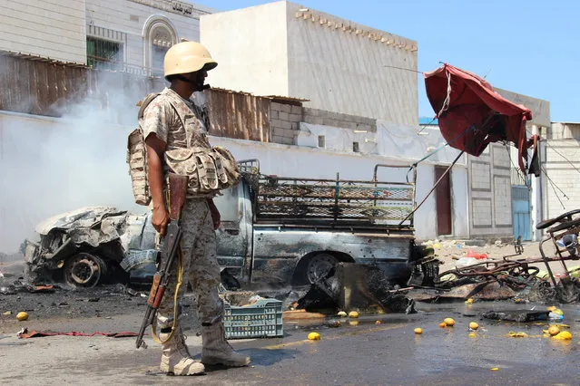 A soldier stands at the site of a car bomb attack in a central square in the port city of Aden, Yemen, May 1, 2016, that targeted the city's security chief for the second time in a week. (Photo by Fawaz Salman/Reuters)