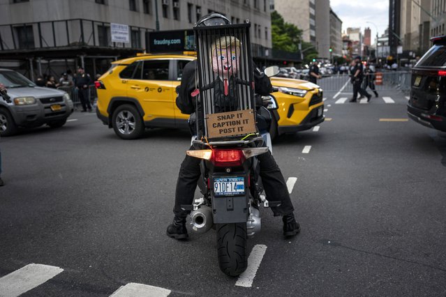 A motorcyclist circles the block with a figure depicting former President Donald Trump moments after was found guilty on 34 felony counts of falsifying business records in the first degree at Manhattan Criminal Court in New York, NY on Thursday, May 30, 2024. Trump became the first former president to be convicted of felony crimes as a New York jury found him guilty of 34 felony counts of falsifying business records in a scheme to illegally influence the 2016 election through hush money payments to a p*rn actor who said the two had sеx. (Photo by Jabin Botsford/The Washington Post)