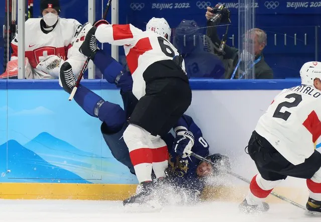 Petteri Lindbohm #40 of Team Finland is checked into the boards by Fabrice Herzog #61 of Team Switzerland during the Men’s Ice Hockey Quarterfinal match between Team Finland and Team Switzerland on Day 12 of the Beijing 2022 Winter Olympic Games at National Indoor Stadium on February 16, 2022 in Beijing, China. (Photo by Bruce Bennett/Getty Images)