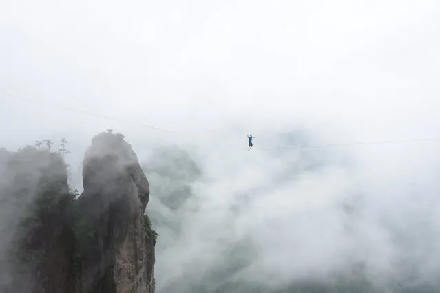 A competitor walks on tightrope during a performance in Taizhou, Zhejiang Province, China, May 7, 2016. (Photo by Reuters/China Daily)