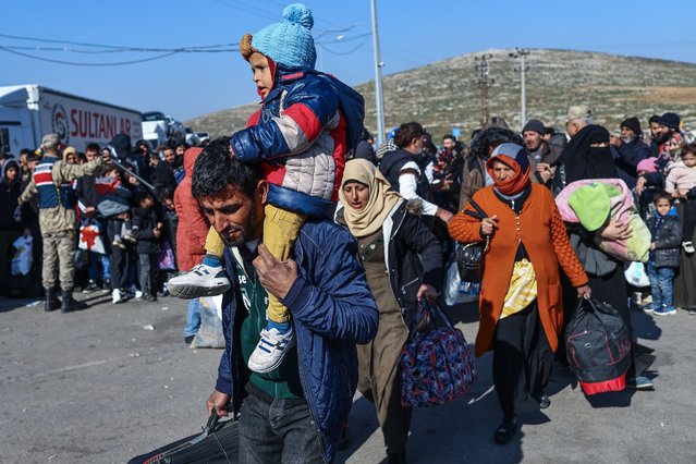 Syrian people, who are living in Hatay city, try to cross the Turkish-Syrian border at Cilvegozu border gate after they were affected by the powerful earthquake, at Reyhanli district in Hatay, Turkey, 16 February 2023. More than 41,000 people have died and thousands more are injured after two major earthquakes struck southern Turkey and northern Syria on 06 February. Authorities fear the death toll will keep climbing as rescuers look for survivors across the region. (Photo by Sedat Suna/EPA/EFE/Rex Features/Shutterstock)