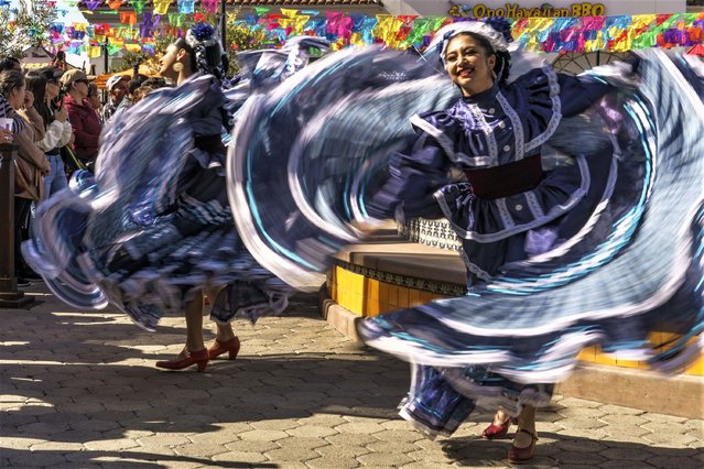 Members of Leyenda Ballet Folklorico from Corona, Calif., dance themes from the provinces of Jalico, Mexico, during the unveiling ceremony of a 4-ton statue of the late Mexican singer Vicente Fernández at Plaza La Alameda in the community of Walnut Park in Los Angeles County, Friday, February 10, 2023. The statute of “El Charro de Huentitán”, riding a horse is identical to one at his gravesite in the Mexican State of Jalisco. Fernández died in December 2021 at age 81. Fernández earned four Grammys and a star on the Hollywood Walk of Fame. (Photo by Damian Dovarganes/AP Photo)
