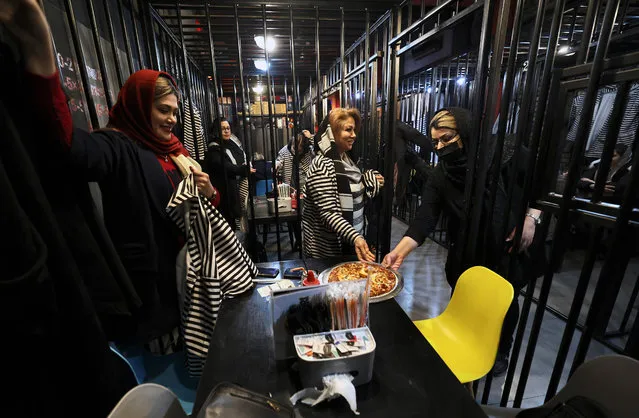 Iranians dine at restaurant-prison “Cell 16” in eastern Tehran on February 4, 2022. Part of the business proceeds is used to free those languishing in Iranian jails for unpaid debts. More than 11,000 Iranians are incarcerated for failing to pay their debts, according to prison officials. The total number of detainees in Iran in 2019 was 240,000, according to the official IRNA news agency. (Photo by Atta Kenare/AFP Photo)
