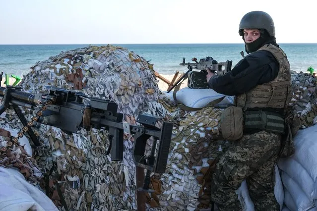 A Ukrainian soldier stands guard with his gun next to barricades at the beachfront near Lusanivka in south Ukrainian city of Odesa, in Ukraine, 21 March 2022. Russian troops entered Ukraine on 24 February prompting the country's president to declare martial law and triggering a series of announcements by Western countries to impose severe economic sanctions on Russia. (Photo by Sedat Suna/EPA/EFE)