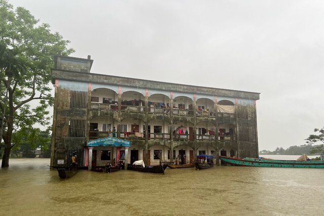 Flood affected people take temporary shelter at a school in Sylhet on June 19, 2024. (Photo by AFP Photo/Stringer)