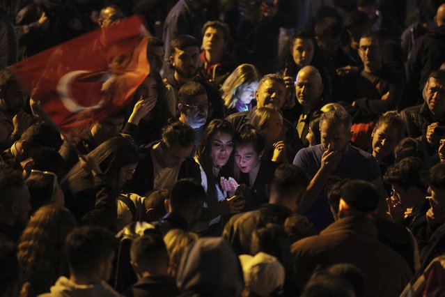 Supporters of Republican People's Party use their cellphones to watch the election results outside the headquarters of CHP, in Ankara, Turkey, Sunday, May 14, 2023. More than 64 million people, including 3.4 million overseas voters, were eligible to vote. (Photo by AP Photo/Stringer)