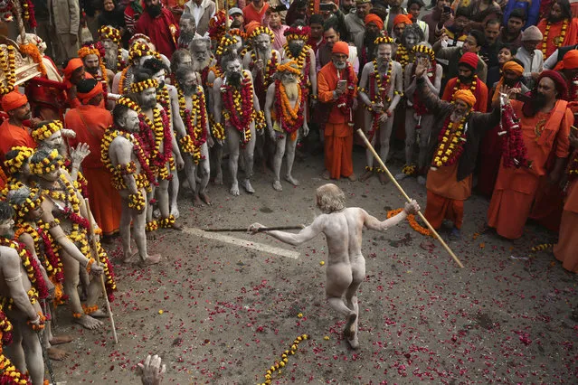 A Naga Sadhu, or a naked Hindu holy man, dances during a procession towards the Sangam, the confluence of rivers Ganges and Yamuna, ahead of the Kumbh Mela in Allahabad, India, Wednesday, January 2, 2019. Kumbh Mela is a 45-days festival beginning later this month where millions of Hindu devotees are expected to attend with the belief that taking a dip in the holy waters will cleanse them of their sins. (Photo by Rajesh Kumar Singh/AP Photo)