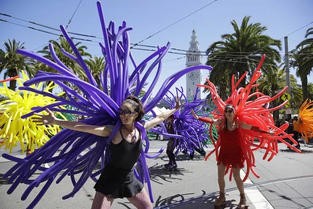 Marchers with Balloon Magic take part in the 44th annual San Francisco Gay Pride parade Sunday, June 29, 2014, in San Francisco. The lesbian, gay, bisexual, and transgender celebration and parade is one of the largest LGBT gatherings in the nation. (Photo by Eric Risberg/AP Photo)