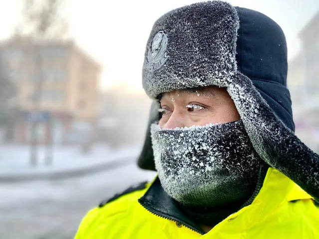 A traffic police officer directs traffic in Mohe City, northeast China's Heilongjiang Province, December 29, 2019. Temperatures in Mohe, “north pole” of China, often stand at below minus 40 degrees Celsius in winter mornings. Photo by Yang Siqi/Xinhua News Agency/Alamy Live News)