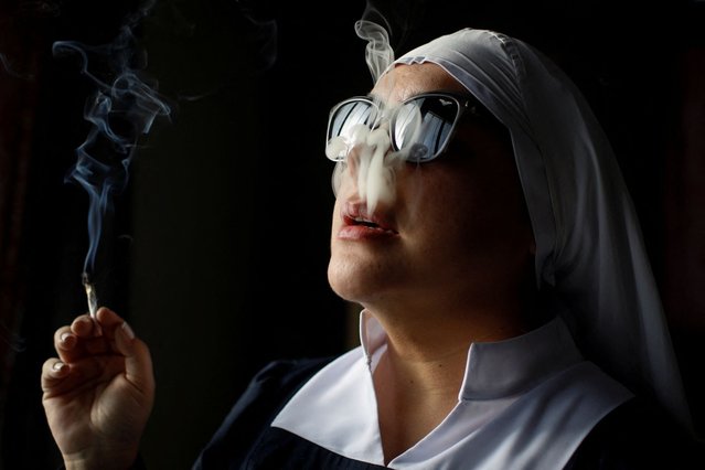 A member of Sisters of the Valley, a non-religious international group founded in 2014 which has pledged to spread the gospel of the healing powers of cannabis, who uses the moniker “Sister Bernardet” online and asked not to give her name for fear of reprisal, smokes a joint at the Sisters of the Valley's farm on the outskirts of a village in central Mexico on September 3, 2023. (Photo by Raquel Cunha/Reuters)