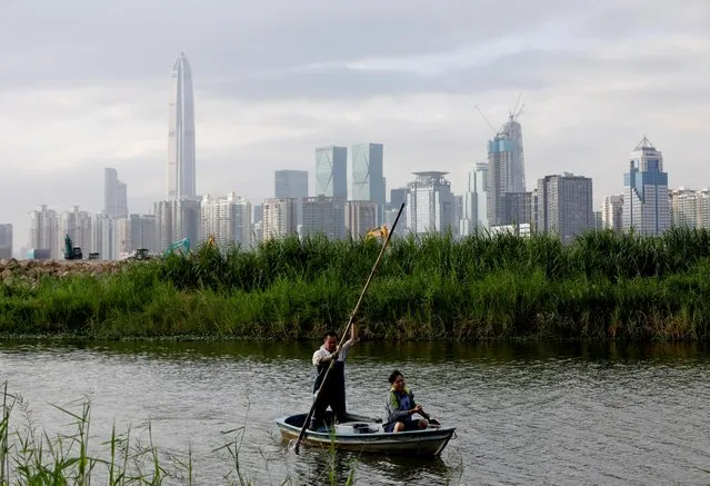 Andrew Kwok returns home from fishing to his farmhouse in Lok Ma Chau village in Hong Kong, China, October 29, 2019. Shenzhen's high rise building can be seen in the distance. (Photo by Kim Kyung-Hoon/Reuters)