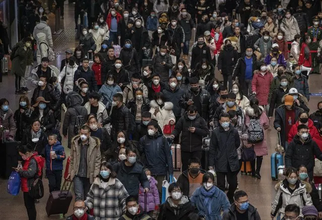 Chinese passengers, most wearing masks, arrive to board trains before the annual Spring Festival at a Beijing railway station on January 23, 2020 in Beijing, China. The number of cases of a deadly new coronavirus rose to over 500 in mainland China Wednesday as health officials locked down the city of Wuhan in an effort to contain the spread of the pneumonia-like disease. Medicals experts have confirmed that the virus can be passed from human to human. In an unprecedented move, Chinese authorities put travel restrictions on the city of 11 million and two other neighboring cities, preventing people from leaving after 10 AM local time Thursday. The number of those who have died from the virus in China climbed to at least 17 on Thursday and cases have been reported in other countries including the United States,Thailand, Japan, Taiwan and South Korea. (Photo by Kevin Frayer/Getty Images)
