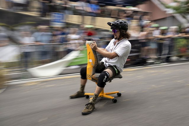 A participant in action during the Office Chair Race World Cup (Buerostuhlrennen Weltmeisterschaft), in Olten, Switzerland on July 1, 2023. (Photo by Anthony Anex/EPA/EFE)