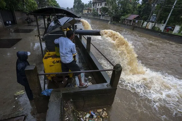 Authorities use a pump to remove water from a flooded road after heavy rainfall in Gauhati, Assam state, India, Thursday, June 16, 2022. (Photo by Anupam Nath/AP Photo)