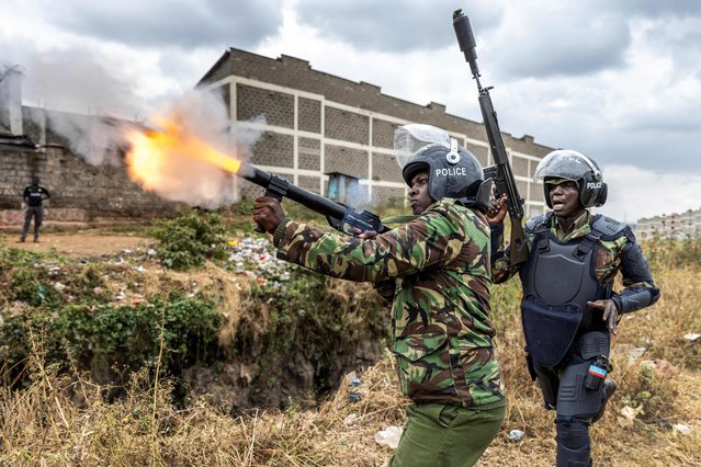 A Kenya Police Officer shoots a tear gas canister to disperse some protesters as they gather to demonstrate in Nairobi, Kenya on July 12, 2023. Kenyan opposition leader Raila Odinga has called once again for countrywide demonstrations on Wednesday as he puts pressure on President William Ruto's administration. Opposition leaders accuse the government of being illegitimate while failing to tackle the high cost of living as they have launched a national campaign to raise signatures from Kenyans in their push to remove President William Ruto from office. (Photo by Luis Tato/AFP Photo)