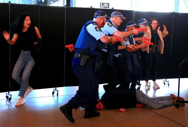 Actors and Australian police officers participate in a training scenario called an 'Armed Offender/Emergency Exercise' held at an international passenger terminal located on Sydney Harbour in Australia, July 27, 2017. (Photo by David Gray/Reuters)