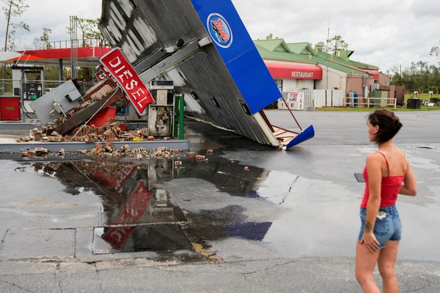 Hope Laird looks at the wreckage of a gas station near her home after the arrival of Hurricane Idalia in Perry, Florida, U.S., August 30, 2023. (Photo by Cheney Orr/Reuters)