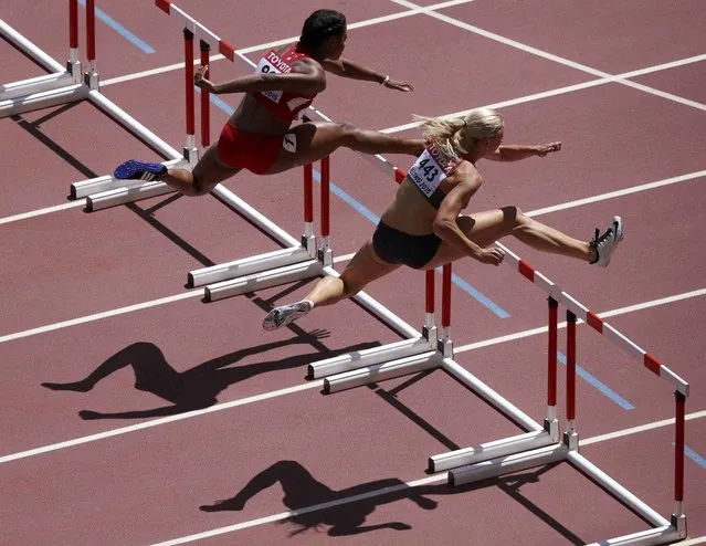 Cindy Roleder of Germany (R) and Sharika Nelvis of the U.S. compete in the women's 100 metres hurdles heats during the 15th IAAF World Championships at the National Stadium in Beijing, China August 27, 2015. (Photo by Dylan Martinez/Reuters)