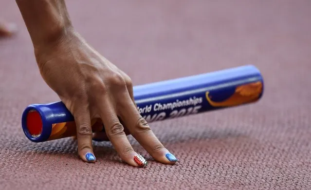 Mariabenedicta Chigbolu of Italy holds the baton at the start of the women's 4 x 400 metres relay heat during the 15th IAAF World Championships at the National Stadium in Beijing, China August 29, 2015. (Photo by Dylan Martinez/Reuters)