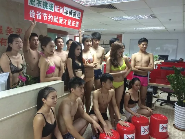 People wearing bikinis and swimming costumes, attend a stripe off challenge to reject the ice bucket challenge for its water wasting on August 26, 2014 in Shenzhen, Guangdong province of China. People wearing swimming costumes attended a stripe off challenge to provoke the idea of water saving and reject ice bucket challenge for its water wasting. (Photo by ChinaFotoPress/ChinaFotoPress via Getty Images)