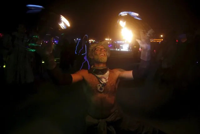 Sir Diamond Stallion, his Playa name, dances with fire during the Burning Man 2015 “Carnival of Mirrors” arts and music festival in the Black Rock Desert of Nevada September 5, 2015. (Photo by Jim Urquhart/Reuters)