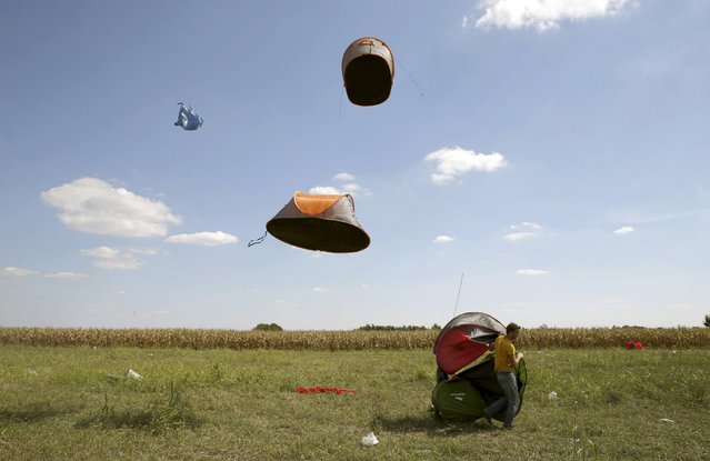 Migrants' tents are blown off by the wind near a collection point in the village of Roszke, Hungary September 9, 2015. Hungary has closed its M5 highway after groups of migrants broke through a police cordon at Roszke on the border with Serbia on Wednesday and set off on foot towards the motorway, police said on their website. (Photo by Marko Djurica/Reuters)