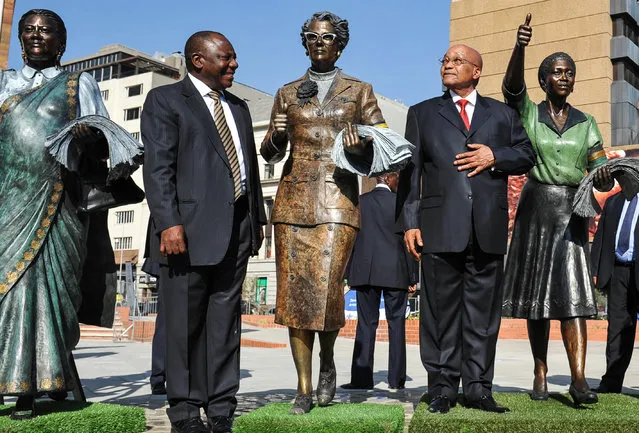 Deputy President Cyril Ramaphosa, left, and President Jacob Zuma, right, stand among recently unveiled statues of women who took part in a 1956 protest march to Pretoria, during Women's Day celebrations in Pretoria, South Africa, Tuesday August 9, 2016. In speaking during celebrations Zuma avoided making any reference to an anti-rape protest against him on live television days earlier. (Photo by AP Photo)