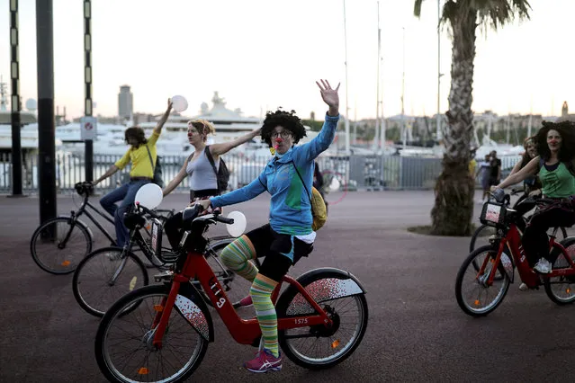 People wearing red clown noses ride their bicycles, as some Spanish provinces are allowed to ease lockdown restrictions during phase one, amid the coronavirus disease (COVID-19) outbreak, in Barcelona, Spain, May 28, 2020. (Photo by Nacho Doce/Reuters)