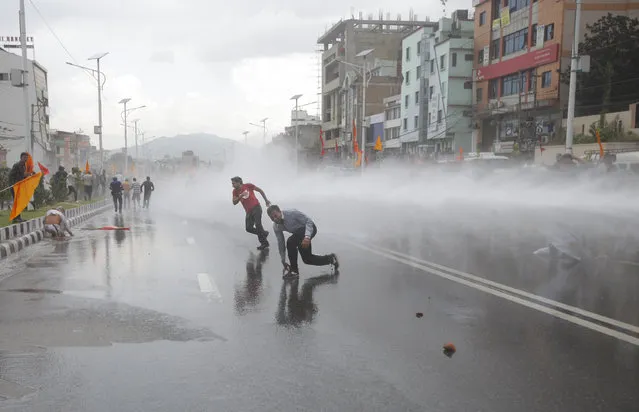 Nepalese police use water cannon to disperse Hindu protestors after they tried to enter a restricted area near the Constituent Assembly hall in Kathmandu, Nepal, Monday, September 14, 2015. Nepal's Constituent Assembly rejected calls to revert the Himalayan nation back to a Hindu state during voting on a draft of the long-delayed new constitution. (Photo by Bikram Rai/AP Photo)