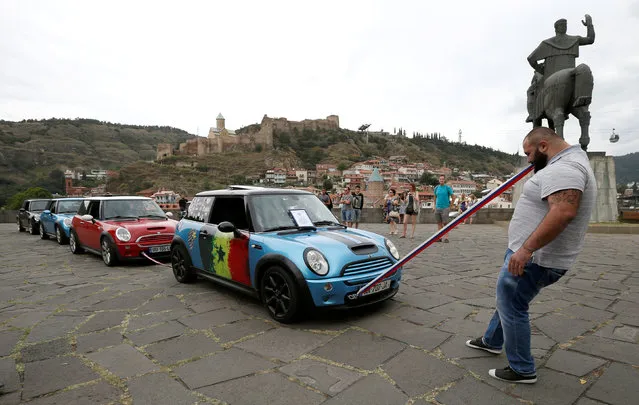 Guram Ustiashvili, 22, pulls four cars with his teeth during an attempt to set a world record in Tbilisi, Georgia, August 16, 2016. (Photo by David Mdzinarishvili/Reuters)