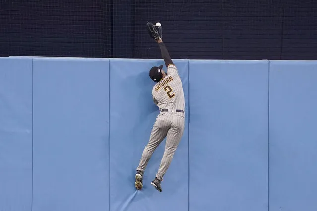 San Diego Padres center fielder Trent Grisham leaps for but cannot catch a solo home run by Los Angeles Dodgers' Freddie Freeman during the first inning in Game 2 of a baseball NL Division Series, Wednesday, October 12, 2022, in Los Angeles. (Photo by Mark J. Terrill/AP Photo)