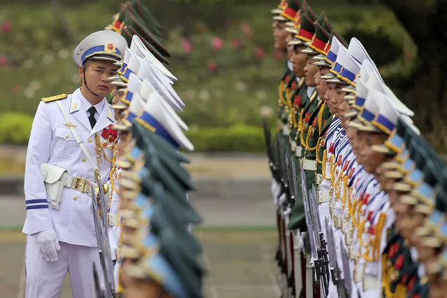 A member of the honor guard checks the line before the welcome ceremony of U.S. President Donald Trump at the Presidential Palace in Hanoi, Vietnam, Sunday, November 12, 2017. (Photo by Luong Thai Linh/Pool Photo via AP Photo)