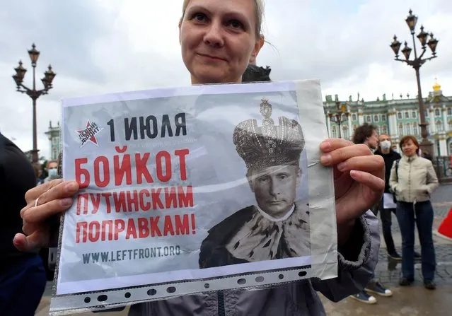 A woman holds a placard reading “Boycott to Putin's amendments” as she protests against amendments to the Constitution of Russia on Dvortsovaya Square in downtown Saint Petersburg on July 1, 2020, as Russians vote in the final day of a ballot on constitutional reforms allowing President Putin to potentially stay in power until 2036. (Photo by Olga Maltseva/AFP Photo)