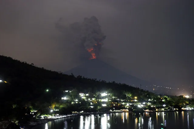 A view of the Mount Agung volcano erupting in Karangasem, Bali, Indonesia, Monday, November 27, 2017. Indonesia authorities raised the alert for the rumbling volcano to highest level on Monday and closed the international airport on the tourist island of Bali stranding thousands of travelers. (Photo by Firdia Lisnawati/AP Photo)