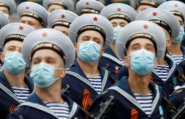 Militants of the self-proclaimed Donetsk People's Republic, wearing protective masks against the coronavirus disease (COVID-19) spread, march during a rehearsal for the Victory Day Parade in Donetsk, Ukraine, June 22, 2020. The military parade marking the 75th anniversary of the victory over Nazi Germany in World War Two was planned for May 9 but postponed due to the coronavirus outbreak. (Photo by Alexander Ermochenko/Reuters)