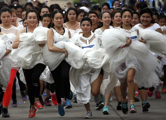 Thai brides-to-be compete in the “Running of the Brides” event in Bangkok, Thailand, 02 December 2017. Six hundred of to be brides and their grooms compete a run race aimed to win more than two million baht (61,000 US dollars or 51,000 euro) of wedding package prizes including a pair of white gold diamond rings and honeymoon trip to the Maldives. (Photo by Rungroj Yongrit/EPA/EFE/Rex Features/Shutterstock)