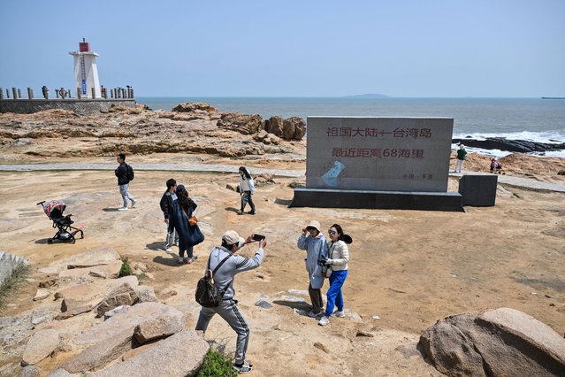 People visit the scenic spot called 68 Nautical Miles on Pingtan island, the closest point between China and Taiwan's main island, in Fujian province on April 2, 2025. (Photo by Héctor Retamal/AFP Photo)