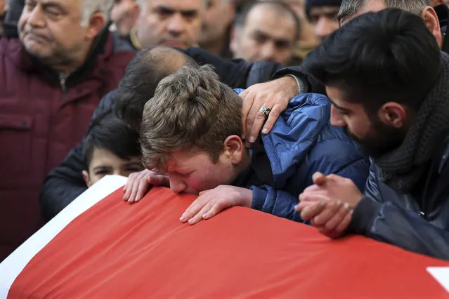 Family and friends mourn on January 1, 2017, during the funeral for Ayhan Akin, one of the victims of a shooting at a nightclub in Istanbul. An assailant, believed to have been dressed in a Santa Claus costume, opened fire at a nightclub in Istanbul's Ortakoy district during New Year's celebrations, killing dozens of people and wounding dozens of others in what the province's governor described as a terror attack. (Photo by AP Photo/Stringer)