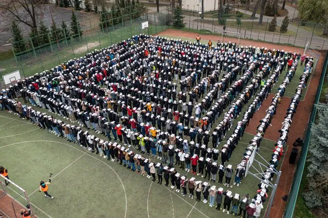 A photo taken with a drone shows students taking part in an attempt to break the Guinness World Record for staging a living chain of the number Pi and its decimal places by students of The Road, Geodesy and High School Complex together with the Technical and Comprehensive School Complex in Jaroslaw, Poland, 30 November 2022. The task of the attempt was to create the longest expansion of Pi with its ddecimal places. The living chain was created by 995 people; more than 883 students of the University of Lodz. (Photo by Darek Delmanowicz/EPA/EFE)