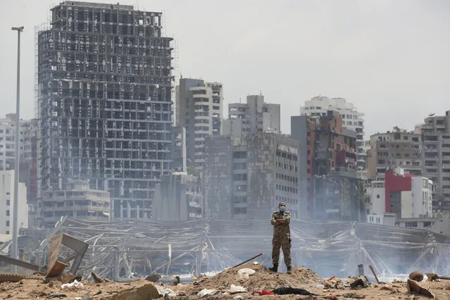 A soldier stands at the devastated site of the explosion in the port of Beirut, Lebanon, Thursday, August 6, 2020. French President Emmanuel Macron came in Beirut to offer French support to Lebanon after the deadly port blast. (Photo by Thibault Camus/AP Photo/Pool)