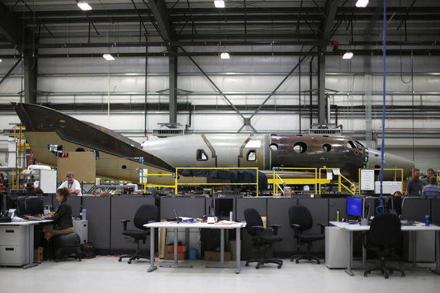 Virgin Galactic's new spaceship N202VG, which the company began building 2 and a half years ago, is seen in a hangar at Mojave Air and Space Port in Mojave. (Photo by Lucy Nicholson/Reuters)