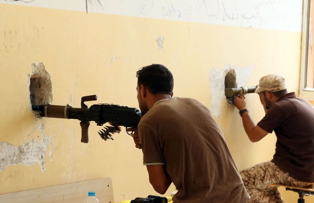 Members of the forces loyal to Libya's UN-backed Government of National Accord (GNA) guard a look-out point in the coastal city of Sirte, east of the capital Tripoli, during their military operation to clear the Islamic State group's (IS) jihadists from the city on September 19, 2016. (Photo by Mahmud Turkia/AFP Photo)