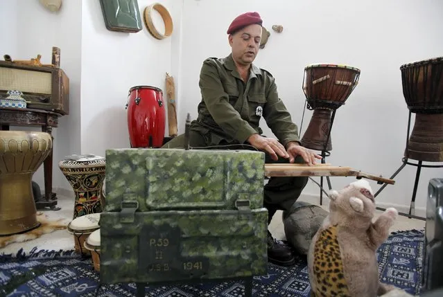 Tunisian Army retiree Belgacem Majri plays music using homemade musical instruments that he built using arms such as bombs and missiles, in Tunis, Tunisia October 20, 2015. (Photo by Anis Mili/Reuters)