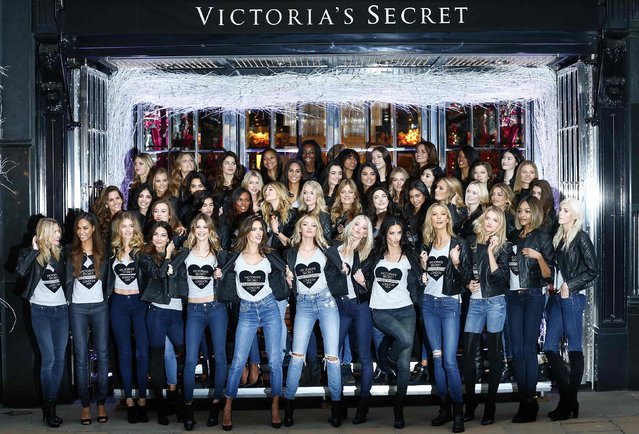 Models pose for a group photograph outside the Victoria's Secret shop on New Bond Street in central London, December 1, 2014. (Photo by Andrew Winning/Reuters)