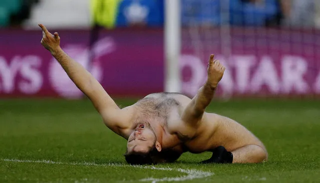 A male streaker on the pitch during a Scotland-Qatar friendly in Edinburgh, June 2015. (Photo by Russell Cheyne/Reuters)