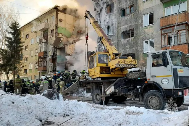 In this photo released by the Russian Emergency Ministry Press Service, Emergency service employees work at a site of a five-story residential building collapsed after the gas explosion in the Siberian city of Novosibirsk, Russia, Thursday, February 9, 2023. Authorities say a gas explosion in an apartment building in the Siberian city of Novosibirsk has killed at least five people including a 2-year-old child. The explosion at 7:43 a.m. on Thursday caused two entrances of the five-story building to collapse, with 30 apartments destroyed by the ensuing fire. (Photo by Russian Emergency Ministry Press Service via AP Photo)