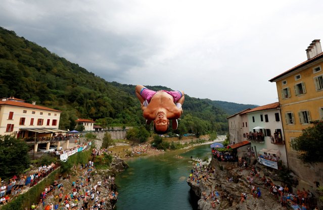 A man jumps from a 17-meter-high bridge during a diving competition, in Kanal, Slovenia, on August 17, 2025. (Photo by Borut Zivulovic/Reuters)